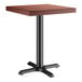 A Lancaster Table & Seating square wooden table with a mahogany finish and a black base plate.