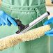 A gloved hand using an Ettore Pro+ 22" T-Bar Window Washer.