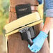 A man using an Ettore double-loop holster for window cleaning tools.