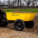A yellow Gorilla dump cart with dirt in it.