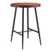 A Lancaster Table & Seating round table with a wood surface and black base.