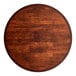 A Lancaster Table & Seating round wooden table top with a mahogany finish.