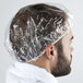 A man wearing a Basic Earth Botanicals shower cap over his hair.