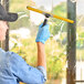 A person using an Ettore window squeegee to clean a window.