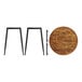 A Lancaster Table & Seating round butcher block table top on two metal legs.