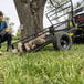 A man pushing a Gorilla heavy-duty steel cart with rocks in it.