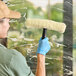 A woman using an Ettore Golden Glove window washer to clean a window.