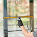 A person cleaning a window with an Ettore Super Channel squeegee.