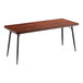 A Lancaster Table & Seating butcher block table with mahogany finish and black legs.