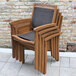 An Outdoor Interiors Eucalyptus wooden arm chair with a black seat and back.