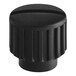 A black plastic knob with a round center.