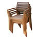 A stack of Outdoor Interiors Eucalyptus Danish stackable arm chairs with wooden arms.