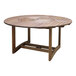 An Outdoor Interiors round wooden table with a circular top on a table.