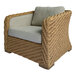 An Outdoor Interiors Sahara wicker arm chair with a cushion.