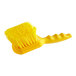 A close-up of a Lavex yellow utility and pot scrub brush with a handle.