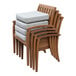 An Outdoor Interiors stack of Eucalyptus arm chairs with beige cushions stacked on top of each other.