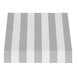 A close-up of a gray and white striped Awntech New Yorker fixed fabric awning with rigid valance.