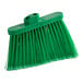 A close up of a green Lavex broom head with angled bristles.