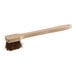 A Lavex wok brush with a wooden handle.