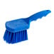 A close-up of a Lavex blue polyester floating pot scrub brush with a handle.