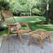 An Outdoor Interiors Teak and Wicker Bohemian Basket Lounger and ottoman on a stone patio.