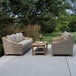 An Outdoor Interiors teak and ash wicker coffee table on a patio.