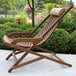 An Outdoor Interiors Eucalyptus Swing Lounger with a cushion on it on a patio.