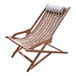 An Outdoor Interiors Eucalyptus Swing Lounger with a white pillow on it.