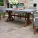 An Outdoor Interiors composite and eucalyptus table and chairs on an outdoor patio.