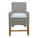 An Outdoor Interiors wicker chair with white cushion on a wooden frame.