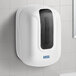 A white Lavex self-adjusting center pull paper towel dispenser on a white tile wall.