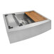 A Ruvati stainless steel farmhouse sink with a wood tray.