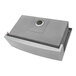 A Ruvati stainless steel farmhouse sink with a lid on the drain.