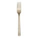 A close-up of a Reserve by Libbey Santorini Gold stainless steel dinner fork with a white background.