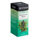 A box of Stash Moroccan Mint Green Tea Bags on a table with text and images of mint and a plant.
