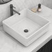 A white square Ruvati Vista above-counter sink on a marble counter with a black faucet.