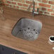 A Ruvati stainless steel sink in a counter.