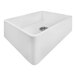 A white Ruvati Fiamma farmhouse sink with a drain in the center.
