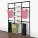 A black Udizine retail clothing display rack with clothes on hangers.