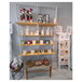 A UDIZINE white wall-mounted retail clothing display with shelves and a sign.