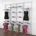 A white Udizine retail clothing display rack with clothes on swingers.