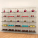 A white Udizine retail clothing display with shelves holding shoes and bags.