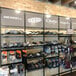 A black wall-mounted display for retail clothing shelves.