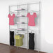 A white Udizine retail clothing display rack with clothes hanging on it.