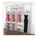 A white Udizine retail clothing display rack with dresses on shelves and hanging rails.