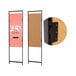 A black wood panel adapter for Vertik retail clothing displays on two doors with pink rectangular signs with black text.