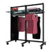 A black Udizine mobile retail clothing display rack with clothes on it.