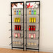 A black wall-mounted retail clothing display with two shelves holding various products.