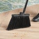 A Lavex angled broom sweeping the floor.