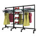 A black mobile retail clothing display rack with clothes on hanging rails.